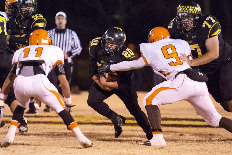 Prairie Grove running back Weston Bartholomew (center) runs the ball as offensive lineman Jacob Lacey blocks Nashville’s Kyler Lawrence (right) during Friday’s Class 4A quarterfinal game in Prairie Grove. 