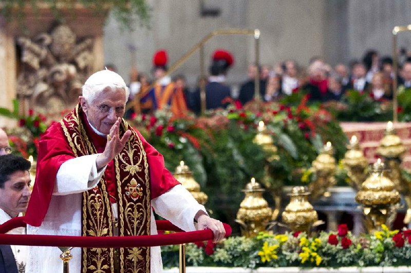 Pope Benedict XVI blesses the crowd Saturday as he leaves St. Peter’s Basilica at the Vatican after a consistory. 