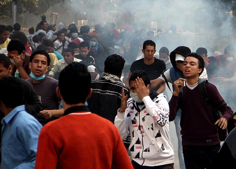 Egyptian protesters clash with security forces, not pictured, near Tahrir Square in Cairo, Egypt, Sunday, Nov. 25, 2012. President Mohammed Morsi edicts, which were announced on Thursday, place him above oversight of any kind, including that of the courts. The move has thrown Egypt's already troubled transition to democracy into further turmoil, sparking angry protests across the country to demand the decrees be immediately rescinded.