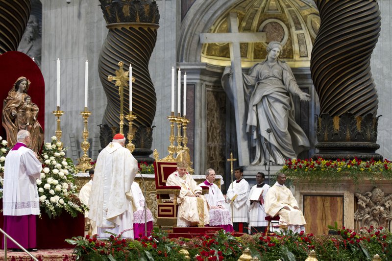 Pope Benedict XVI, center, listens as newly-elected Cardinal James Michael Harvey, second from left, delivers his speech during a mass celebrated for the newly elected cardinals in St. Peter's Basilica at the Vatican, Sunday, Nov. 25, 2012. The pontiff elevated, Saturday, Nov. 24, six new cardinals who joined the elite club of churchmen who will elect his successor, bringing a more geographically diverse mix into the European-dominated College of Cardinals.