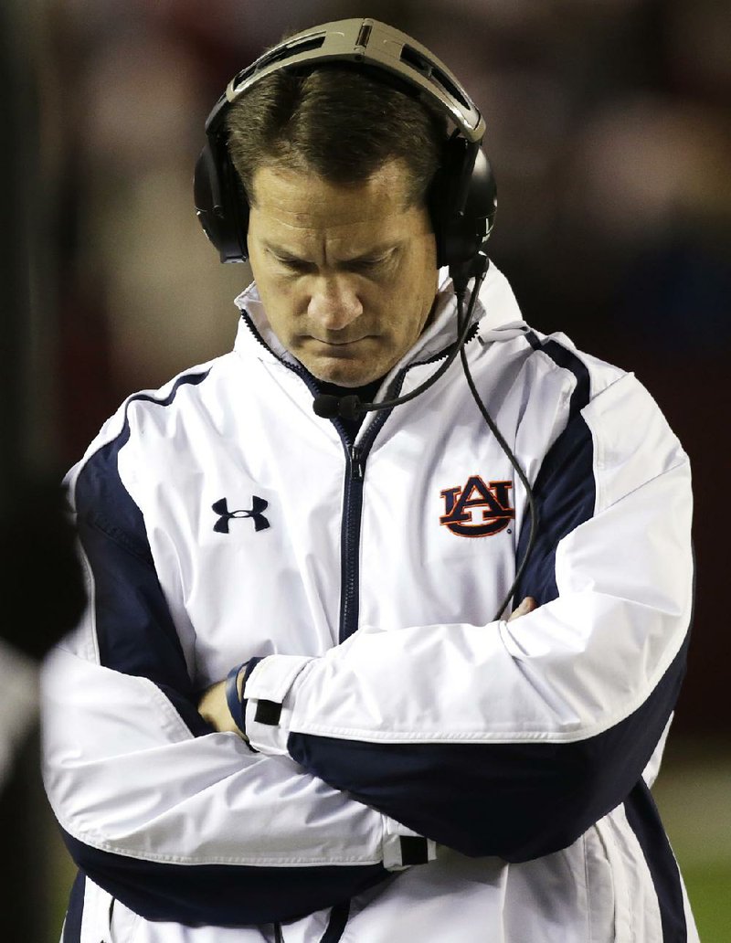 Auburn Coach Gene Chizik walks the sidelines during the second half of Saturday’s 49-0 loss to Alabama at Bryant-Denny Stadium in Tuscaloosa, Ala. Chizik was fired Sunday after a 3-9 season by Athletic Director Jay Jacobs. 