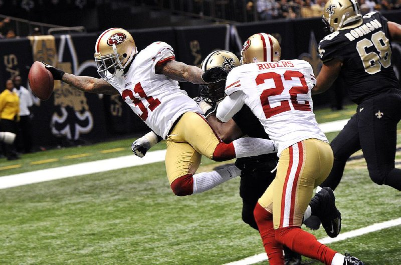 San Francisco strong safety Donte Whitner scores on a 42-yard interception return in the third quarter of the 49ers’ 31-21 victory over the New Orleans Saints on Sunday. 