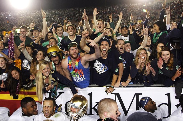 12 down, 1 to go Notre Dame fans celebrate with their team after the Fighting Irish defeated USC 22-13 Saturday night to finish the regular season 12-0. 