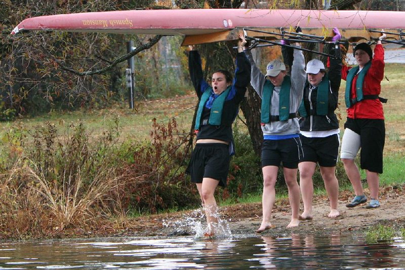 Recent research at Oxford University found that rowers’ pain tolerance improves when they work out in a group. That principle doesn’t appear to apply in this photo from November 2006, as Shannon Goforth (left) winces while stepping into water as her University of Arkansas teammates Olivia Haughey (second from left), Audrey Walker (second from right) and Jessica Keahey (right) put in at Lake Fayetteville. 