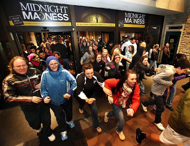 Black Friday shoppers pour into the Valley River Center mall for the Midnight Madness sale in Eugene, Ore., on Friday. 