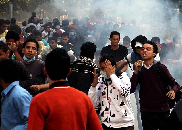 Egyptian protesters clash with security forces near Tahrir Square in Cairo on Sunday. President Mohammed Morsi’s edicts, which were announced on Thursday and place him above oversight of any kind, including that of the courts, are sparking protests across the country. 