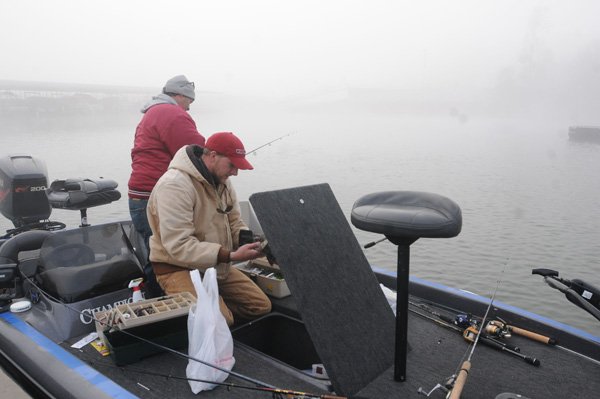 Steve Dickerson, left, of Farmington, and Jon Tuck of Fayetteville wait for fog to lift Wednesday before going fishing at Beaver Lake. The newly formed Beaver Lake Foundation aims to make improvements at the reservoir and parks the Army Corps of Engineeers can’t fund. 