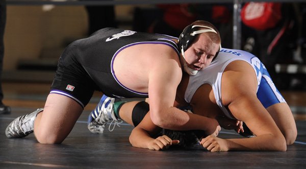 Fayetteville’s Austin Hubble, left, and Rogers’ Juan Balderas compete in the championship bout for the 220-pound division Feb. 4 during the 7A West Conference wrestling meet at Har-Ber High School in Springdale. Go to photos.nwaonline.com to see more photos.