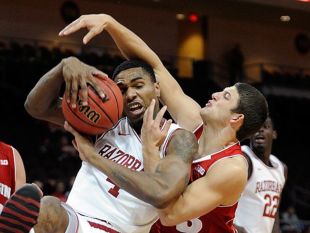 Arkansas' Coty Clarke (4) and Wisconsin's Zak Showalter (33)fight for a rebound during the first half of an NCAA college basketball game at the Continental Tire Las Vegas Invitational tournament on Saturday, Nov. 24, 2012, in Las Vegas. Wisconsin won 77-70. (AP Photo/David Becker) Arkansas' Coty Clarke (4) and Wisconsin's Zak Showalter (33)fight for a rebound during the first half of an NCAA college basketball game at the Continental Tire Las Vegas Invitational tournament on Saturday, Nov. 24, 2012, in Las Vegas. Wisconsin won 77-70. (AP Photo/David Becker)