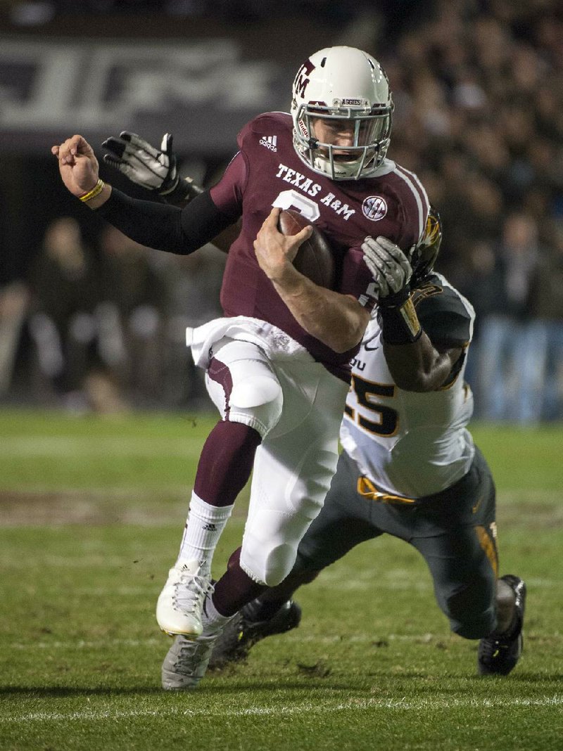 Texas A&M freshman quarterback Johnny Manziel (2) has collected 4,060 yards of total offense, made himself a serious Heisman Trophy contender and led the No. 9 Aggies to a 10-2 record in their first SEC season. The Aggies, who have a rule prohibiting freshmen from talking to the media, lifted the restriction for Manziel on Monday. 
