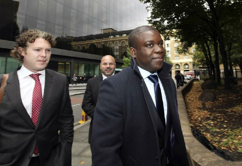 Kweku M. Adoboli (front), a former trader at UBS AG, arrives at Southwark Crown Court in London, in late September. UBS was fined $47.5 million on Monday for failing to prevent a $2.3 billion loss caused by Adoboli. 