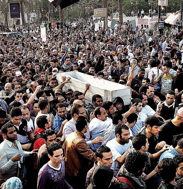 The body of Gaber Salah, who died Sunday from injuries he suffered during clashes with security forces last week, is carried by fellow Egyptians on Monday in Cairo. 