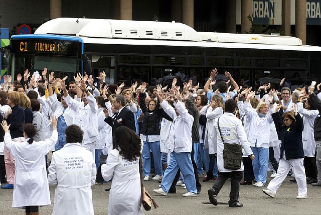 Hospital workers from the Clinico San Carlos in Madrid block traffic outside the hospital Tuesday in a protest against cuts to Spain’s national heath service. The Organization for Economic Cooperation and Development said the Spanish economy will shrink 1.4 percent in 2013. 