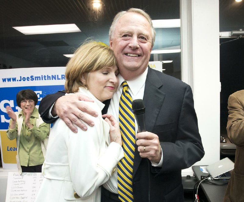 Joe Smith hugs his wife, Missie, on Tuesday evening after winning the runoff for North Little Rock mayor over Tracy Steele. 