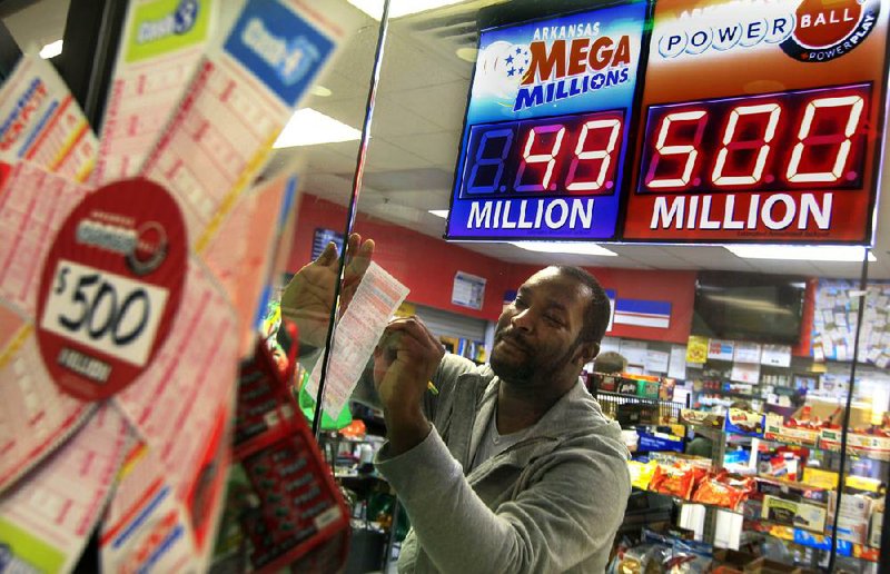 Arkansas Democrat-Gazette/BENJAMIN KRAIN --11/27/12--
Jeremy McCoy picks numbers on a Power Ball lottery ticket at Sufficient Grounds Metro store in Little Rock on Tuesday. The jackpot for $500 million will be drawn Wednesday night.