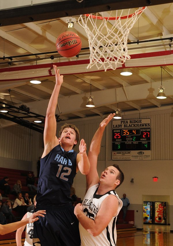 Alex Rice, left, a Springdale Har-Ber senior, shoots as Pea Ridge senior Isaac Mangrum defends in the first half Tuesday at Pea Ridge.