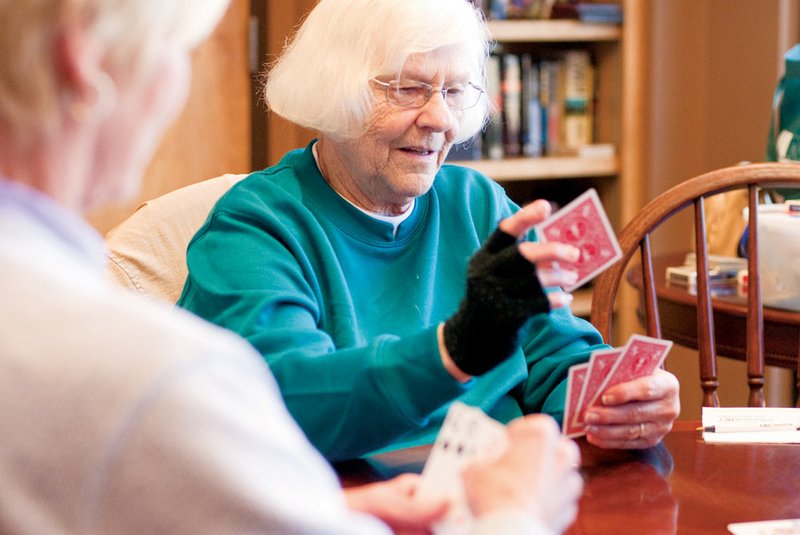 Faye Reaves, center, plays the card game 11-point pitch with Mary Rosenfield, left, and others at the Pope County Senior Activity Center in Russellville.