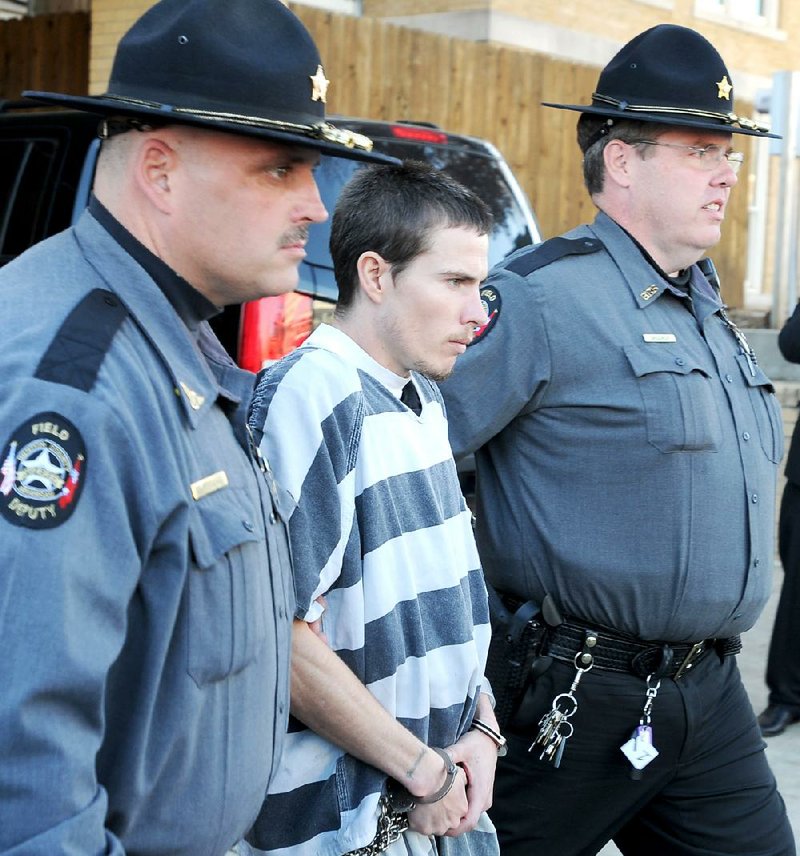 Deputies escort Zachary Holly to a patrol car Wednesday after a bail hearing at the Benton County Courthouse in Bentonville. Holly is charged in the death of Jersey Bridgeman, 6. 