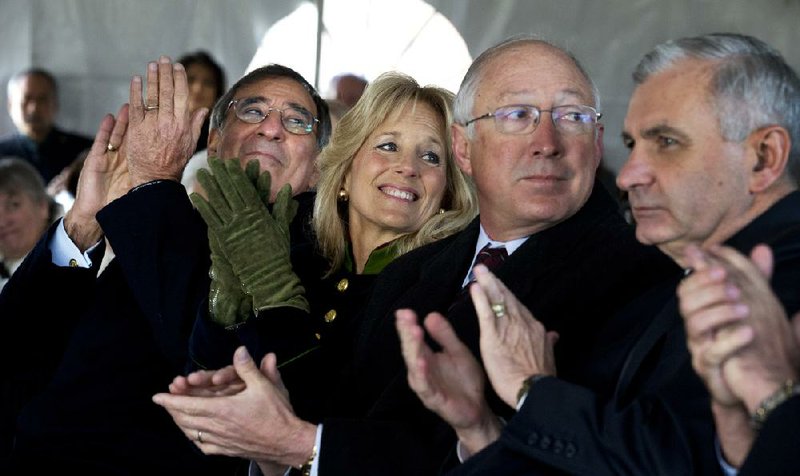 Defense Secretary Leon Panetta (from left); Jill Biden, wife of Vice President Joe Biden; Interior Secretary Ken Salazar; and Sen. Jack Reed, D-R.I., applaud during a groundbreaking ceremony for the Vietnam Veterans Memorial Fund’s next project to honor veterans, the Education Center at The Wall, on Wednesday in Washington. 