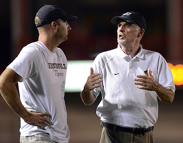 STAFF PHOTO MARC F. HENNING -- Bentonville coach Barry Lunney, right, talks to assistant coach Barry Lunney Jr. during the Tigers' scrimmage Friday, Aug. 24, 2012, against the Redskins at Union-Tuttle Stadium in Tulsa, Okla.