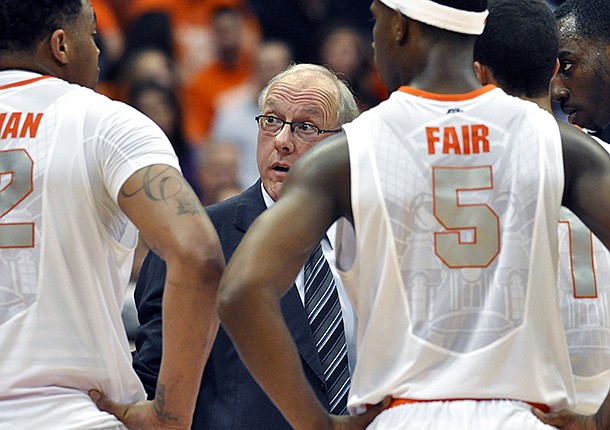Syracuse head coach Jim Boeheim, center, talks with his players during a timeout against Princeton in the second half of an NCAA college basketball game in Syracuse, N.Y., Wednesday, Nov. 21, 2012. Syracuse won 73-53. (AP Photo/Kevin Rivoli)