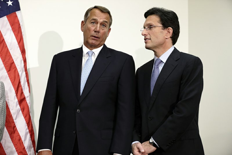 House Speaker John Boehner Ohio, left, talks with House Majority Leader Eric Cantor of Virginia on Capitol Hill in Washington on Wednesday, Nov. 28, 2012, during a news conference after a closed strategy session. 