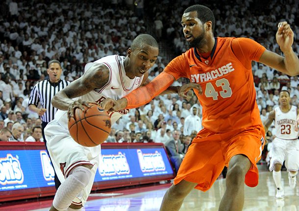 NWA Media/MICHAEL WOODS -- 11/30/2012-- Arkansas guard BJ Young tries to get past past Syracuse defender James Southerland during the first half of Friday night's game at Bud Walton Arena in Fayetteville