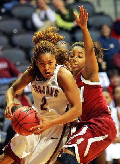 UALR guard Taylor Ford (left) drives to the basket past Troy’s Ashley Beverly-Kelley during their game Thursday night at the Jack Stephens Center. Ford finished with 12 points, 9 rebounds and 8 assists in the Trojans’ 75-52 victory. 