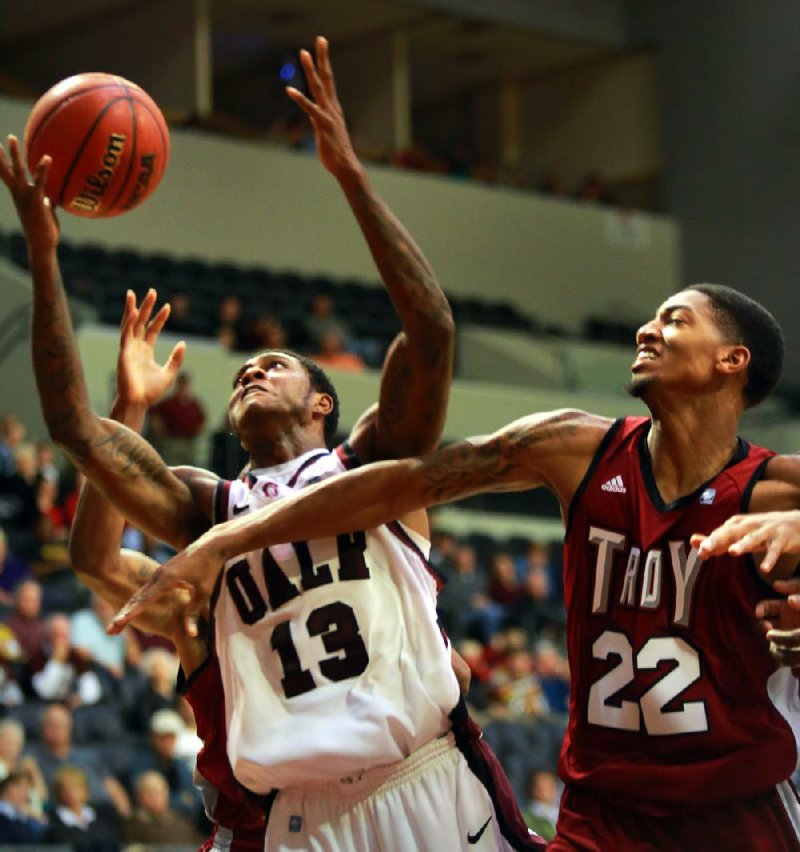 UALR guard Leroy Isler (left) battles for a rebound with Troy forward Tevin Calhoun during the first half of Thursday’s game in Little Rock. 