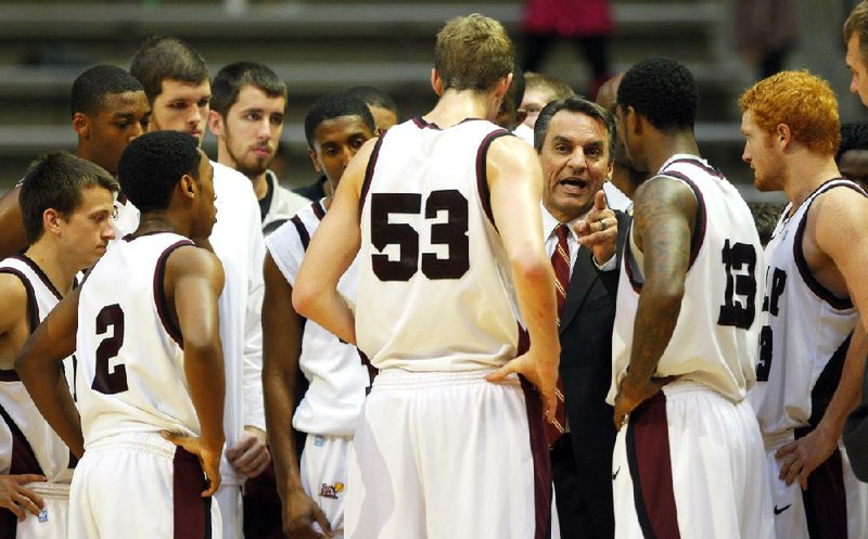 Coach Steve Shields (middle) and the UALR Trojans will look to go 2-0 in Sun Belt Conference play when they host Louisiana-Monroe at 7 p.m. today at the Jack Stephens Center in Little Rock. 