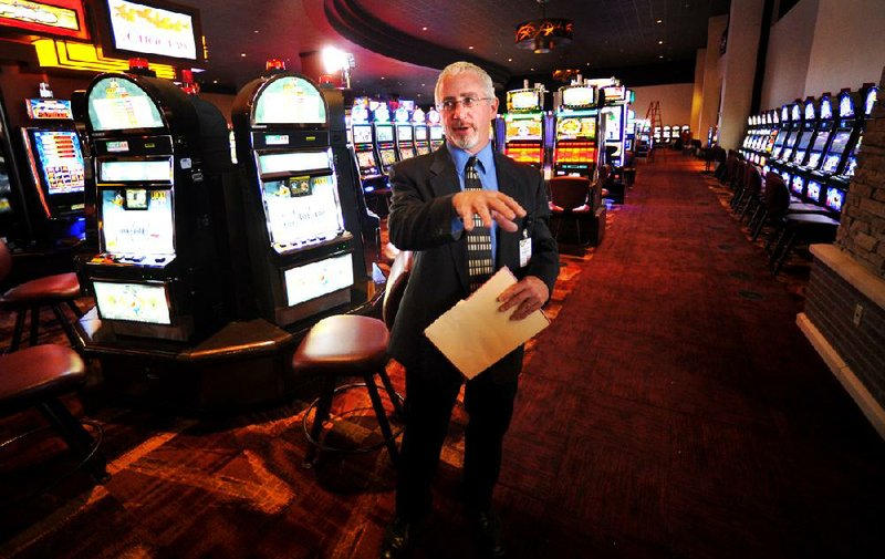 Barrett DeFay, marketing manager for the Choctaw Casino Hotel in Pocola, Okla., stands amid the establishment’s 1,180 slot machines during a tour earlier this week. 