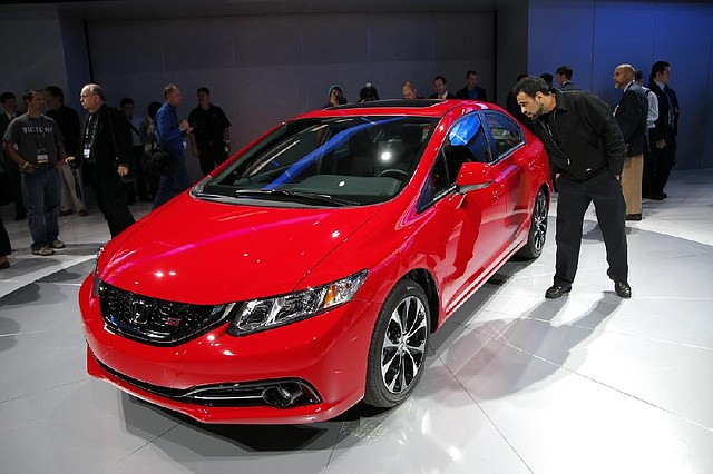 The new Honda Civic is displayed at the Los Angeles Auto Show on Thursday. The show opens to the public today. 