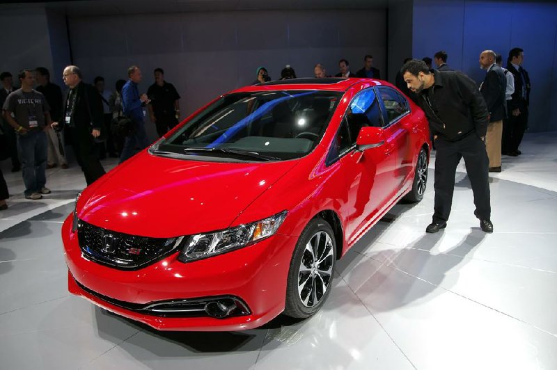 The new Honda Civic is displayed at the Los Angeles Auto Show on Thursday. The show opens to the public today. 