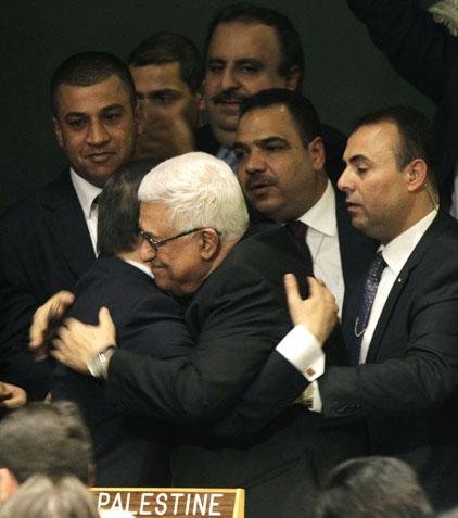 Palestinian President Mahmoud Abbas is embraced Thursday by Turkish Foreign Minister Ahmet Davutoglu after the U.N. General Assembly vote, which Abbas in a speech earlier had called a “last chance.” 