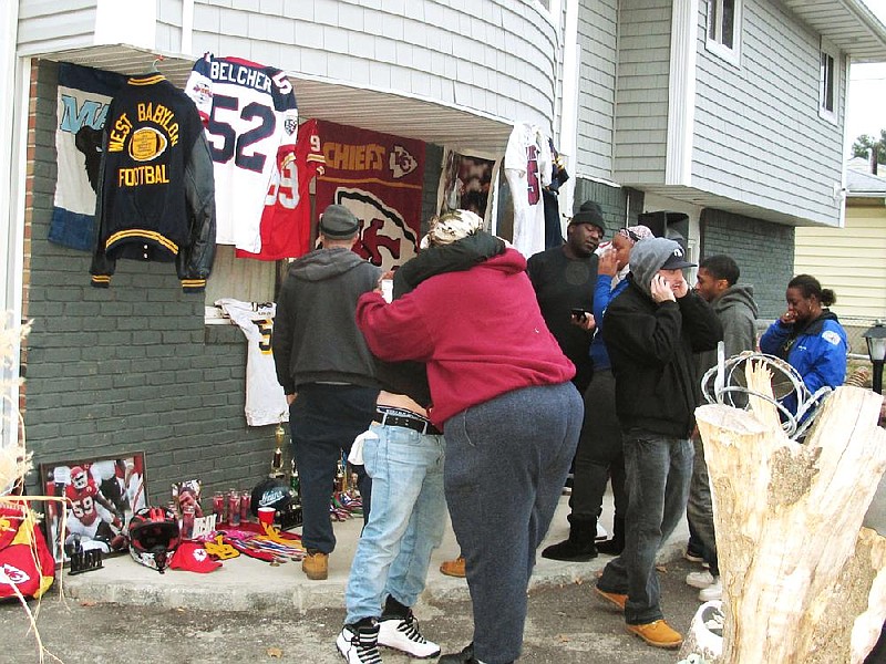 Friends and relatives of Kansas City Chiefs linebacker Jovan Belcher grieve outside the player’s home Saturday in West Babylon, N.Y. Police say the Long Island native shot and killed his girlfriend before taking his own life Saturday in Kansas City. 