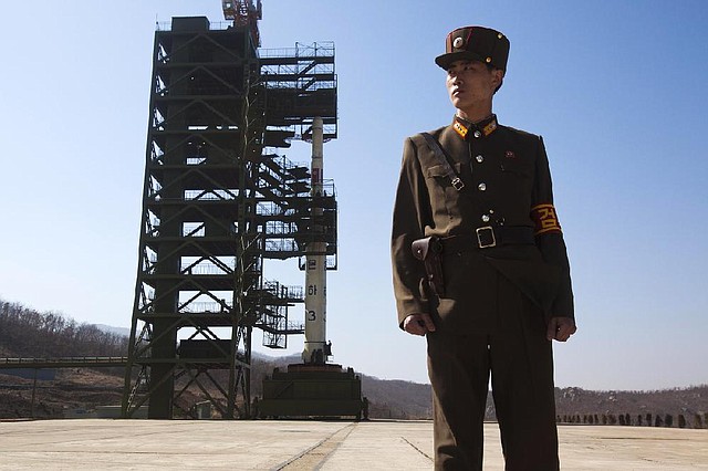 A soldier stands guard over a North Korean Unha-3 rocket at the Sohae Satellite Station in Tongchang-ri in this April 8 photo. Officials announced plans Saturday for another launch of the long-range rocket later this month. 