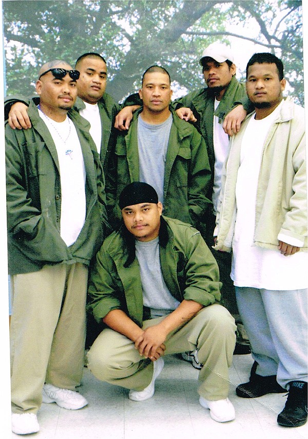 Marshallese residents of Springdale gather at the federal detention center in Oakdale, La., earlier this year where they were being held for deportation proceedings after being convicted of crimes. Standing: Riem Simon, left, Fred John, Jamie Langrus, James Annam and Dewey Gold. Kneeling: Dennis Jinna. John remains in Oakdale. Simon, Langrus, Annam and Jinna were deported. Gold was released and returned to Springdale. 