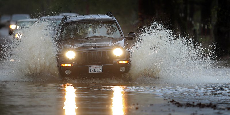 Motorists navigate Piner Road, Friday, Nov. 30, 2012 in Santa Rosa, Calif. The second in a series of storms slammed Northern California on Friday as heavy rain and strong winds knocked out power, tied up traffic and caused flooding along some stretches. 