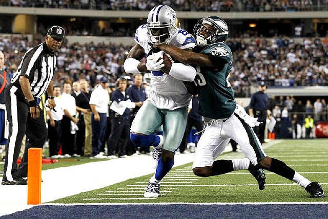 Dallas Cowboys wide receiver Dez Bryant (88) drags Philadelphia Eagles cornerback Dominique Rodgers-Cromartie (23) into the end zone during the second half of Sunday’s game in Arlington, Texas. Bryant scored two touchdowns int he Cowboys’ 38-33 victory. 