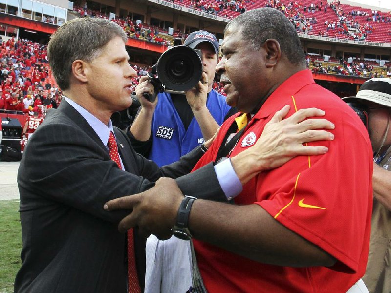 Kansas City Chiefs Coach Romeo Crennel (right) speaks with owner Clark Hunt following Sunday’s game against the Carolina Panthers at Arrowhead Stadium in Kansas City, Mo. 