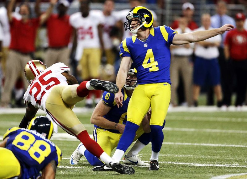 St. Louis Rams place-kicker Greg Zuerlein (right) watches his 54-yard field goal during overtime against the San Francisco 49ers on Sunday at the Edward Jones Dome in St. Louis. The field goal gave the Rams a 16-13 victory. 