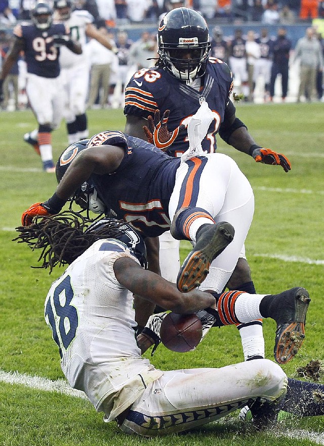 Seattle Seahawks receiver Sidney Rice catches a touchdown pass from quarterback Russell Wilson in overtime against the Chicago Bears as Bears safety Major Wright defends Sunday at Soldier Field in Chicago. 