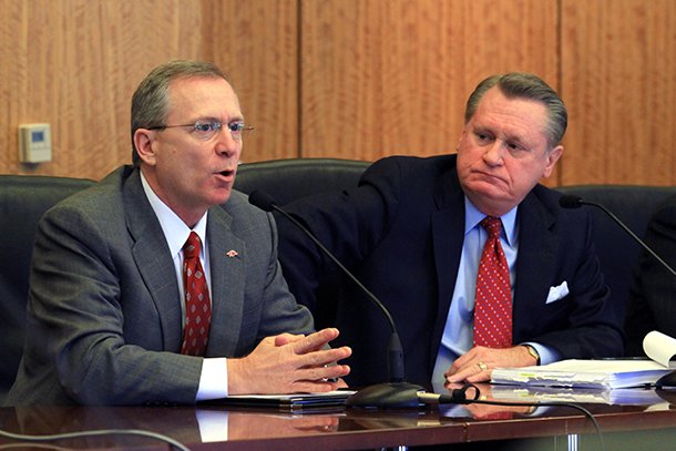 Jeff Long (left) speaks while UA chancellor David Gearhart listens during a UA Board of Trustees meeting in 2012. 