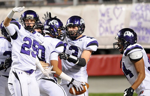 Fayetteville players celebrate after Jordan Dennis’ interception and touchdown in the third quarter Saturday against Bentonville at War Memorial Stadium in Little Rock. 