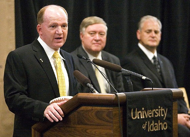 Idaho's new football coach, Paul Petrino, left, speaks while university President Duane Nellis, center, and athletic director Rob Spear listen during a news conference in Moscow, Idaho, on Monday. Petrino replaces interim coach Jason Gesser, who guided the Vandals during the final four games after Robb Akey was fired. Petrino has been the offensive coordinator and quarterbacks coach at Arkansas.