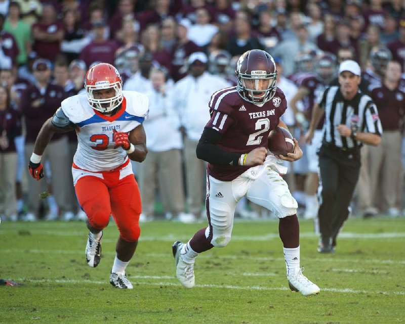 Texas A&M quarterback Johnny Manziel runs past Sam Houston State’s Robert Shaw for a touchdown Nov. 17 at Kyle Field in College Station, Texas. Manziel is one of three finalists for the Heisman Trophy along with Kansas State quarterback Collin Klein and Notre Dame linebacker Manti Te’o. 