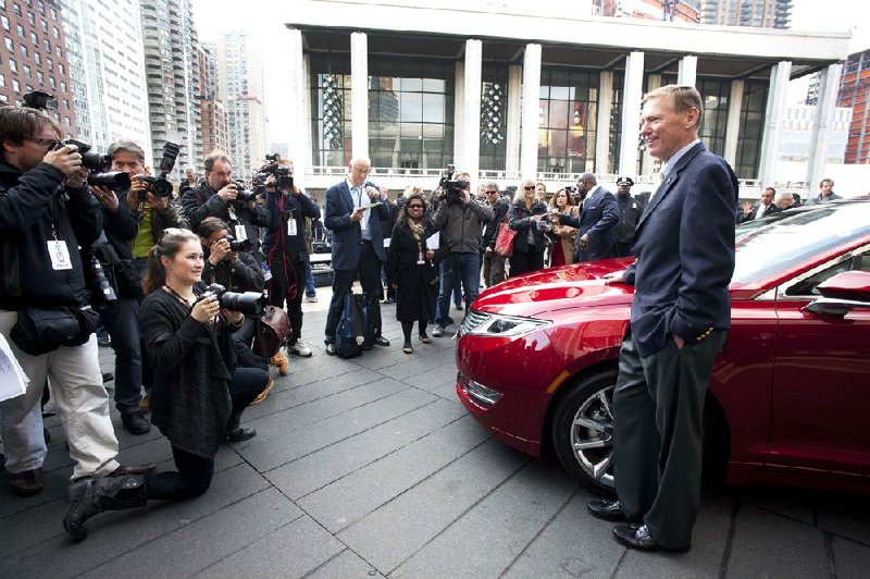 Alan Mulally, Ford Motor Co. president and chief executive officer, stands next to a Lincoln MKZ on Monday in New York. Ford is working to stop a 63 percent slide in Lincoln sales since the luxury line’s peak in 1990. 