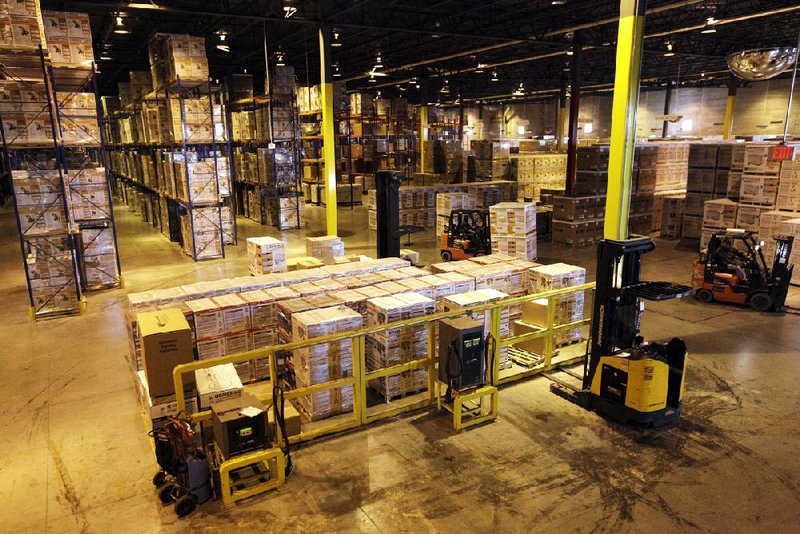 Employees work in a Generac Power Systems Inc. warehouse in Whitewater, Wisc., on Nov. 16. Generac is one of the biggest makers of generators in the U.S. A measure of manufacturing activity in the U.S. fell last month to the lowest point since 2009. 