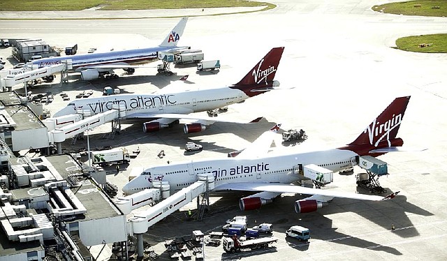 Two Boeing Co. 747 aircraft, operated by Virgin Atlantic, sit at Heathrow Airport’s Terminal 3 near London on Nov. 2. Sources say Delta Air Lines is considering the purchase of Singapore Airlines’ 49 percent stake in Virgin Atlantic. 