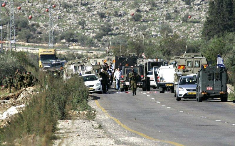 Israeli security forces arrive at the scene after a Palestinian man rammed his car into a military jeep near the West Bank Jewish settlement of Shavei Shomron, near Nablus, on Monday. 
